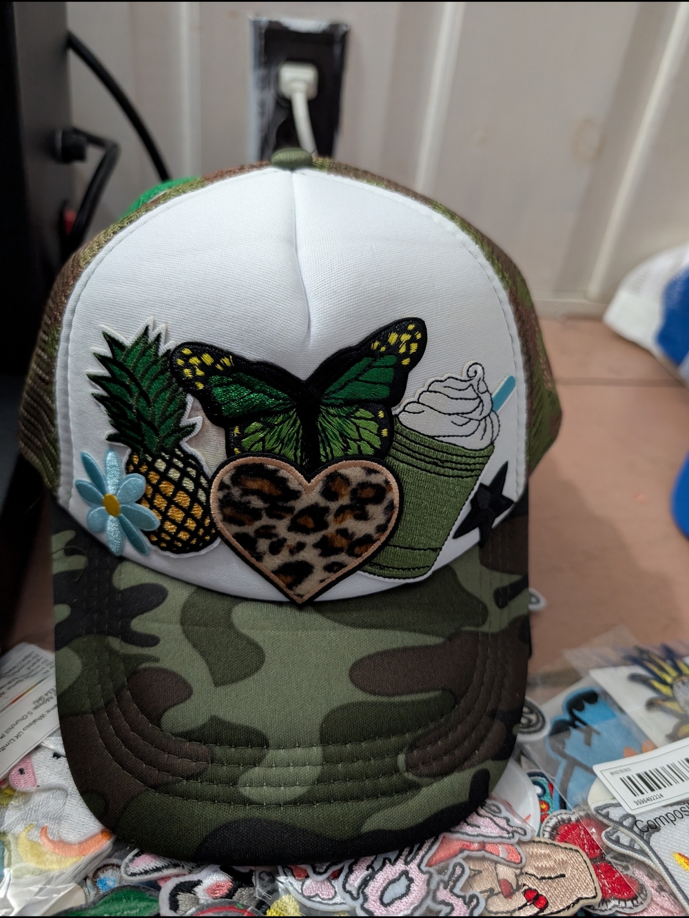Women’s Camo Trucker Hat with Green Butterfly & Pineapple Patch